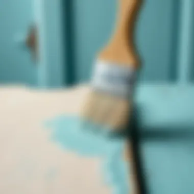 Close-up of a brush applying water-based paint on wood